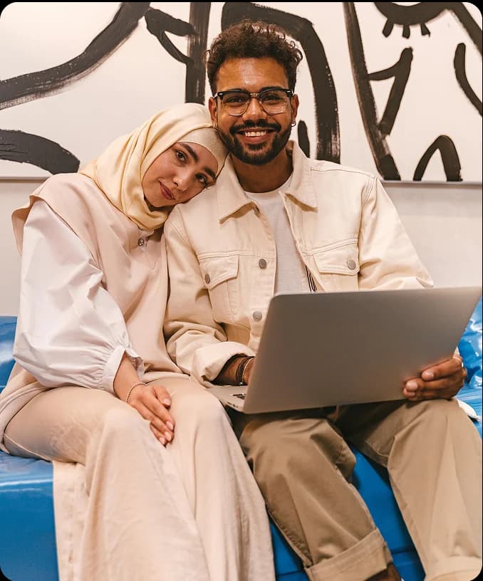 Couple sitting with laptop